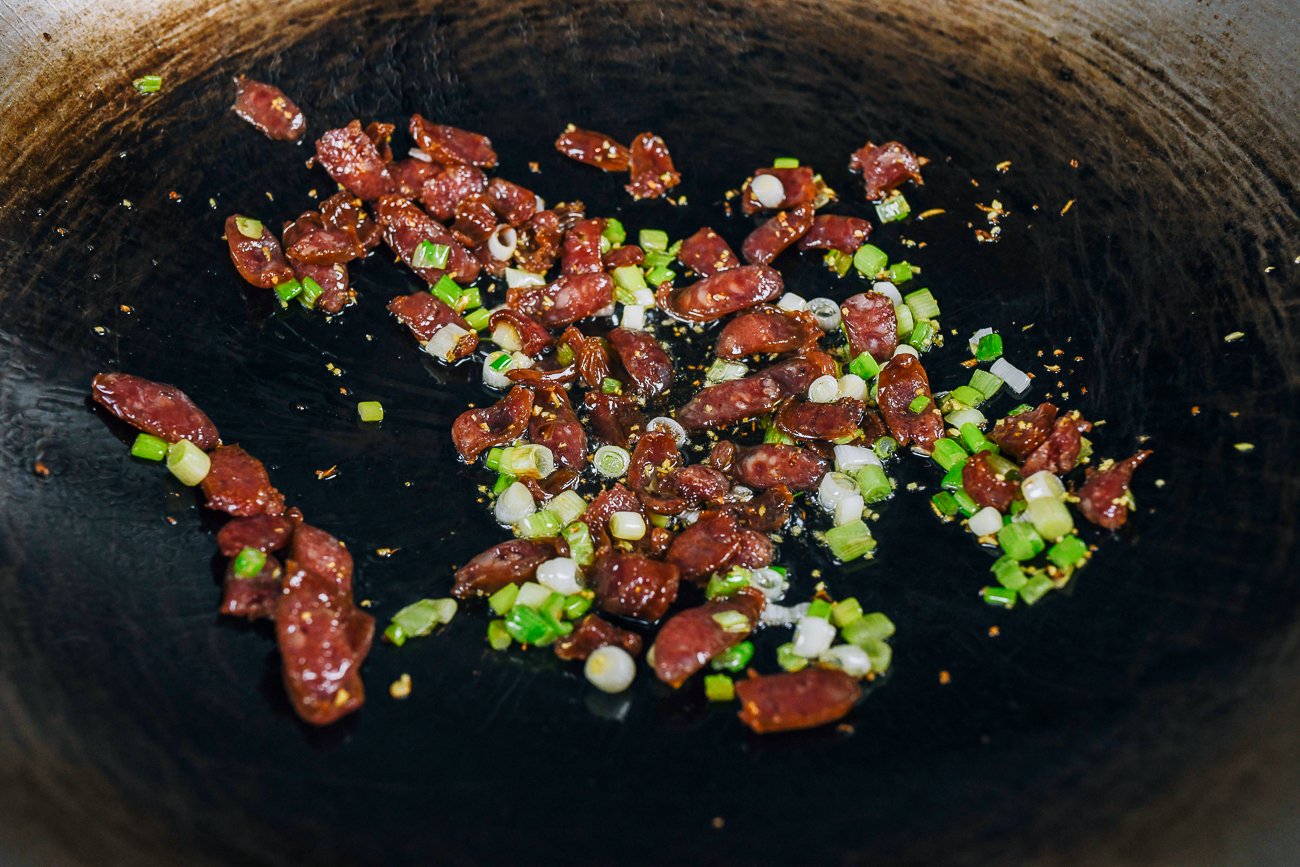 adding Chinese sausage to ginger and scallion