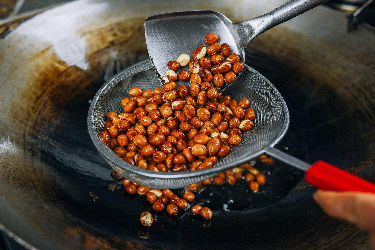 straining peanuts out of oil