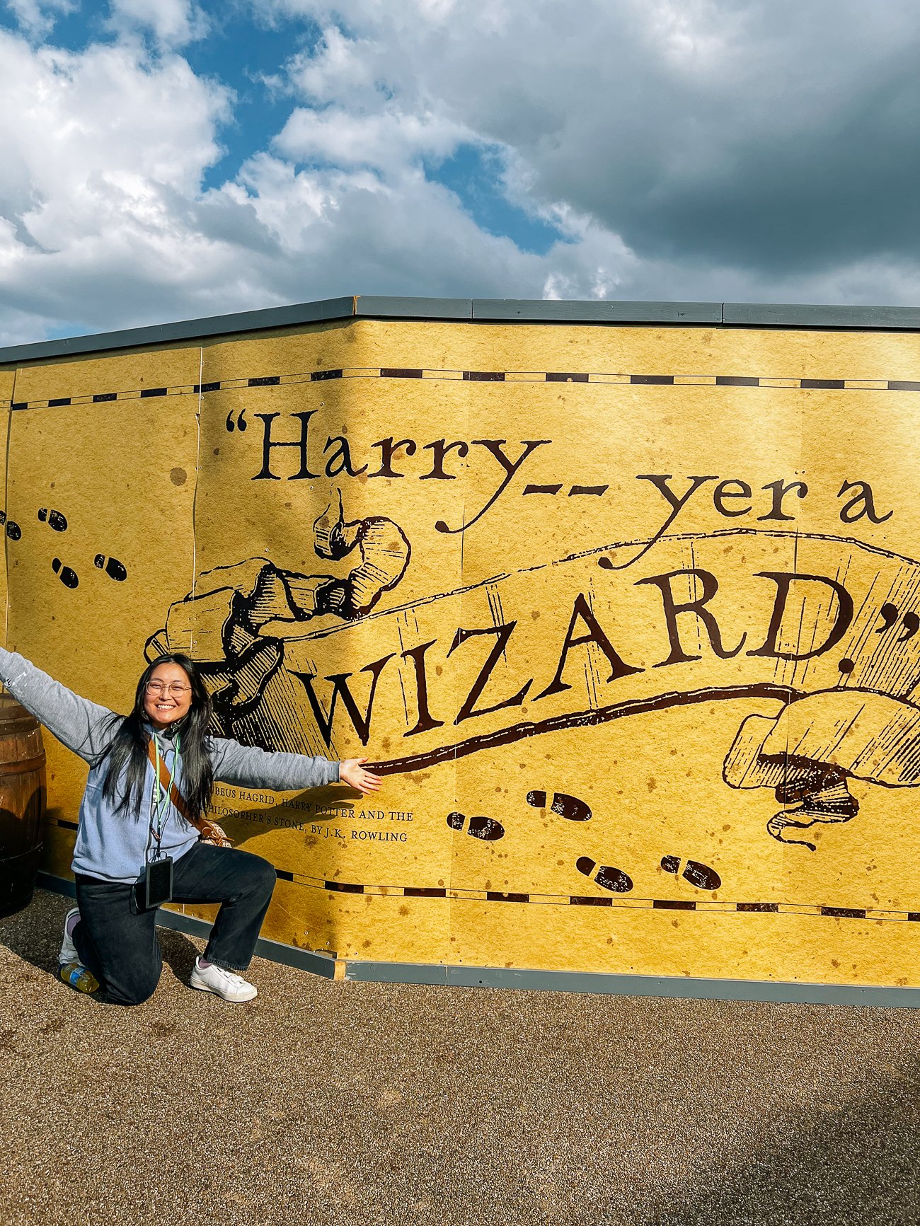 Kaitlin in front of a sign: "Harry—yer a WIZARD"