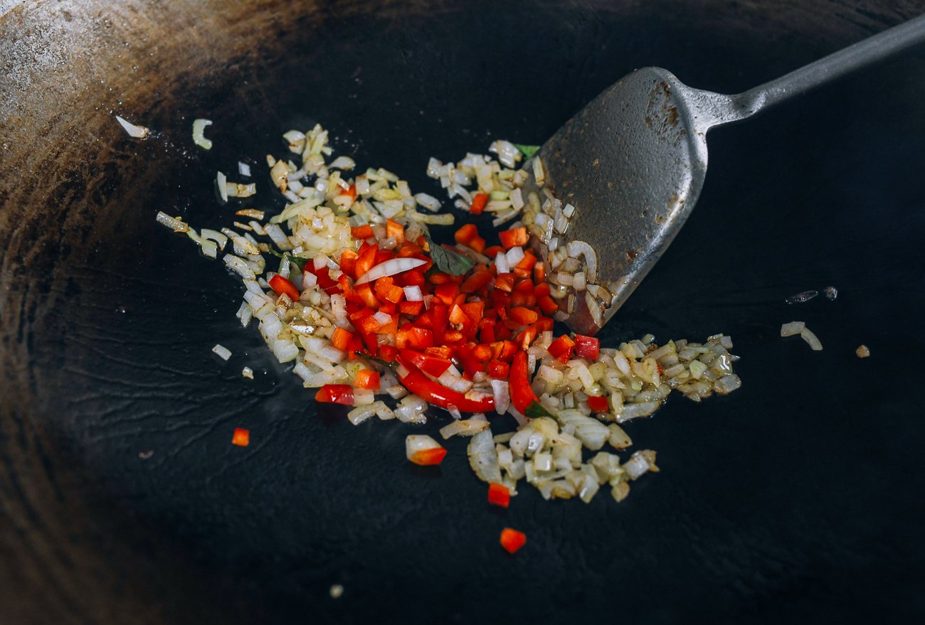 onion and red pepper in wok