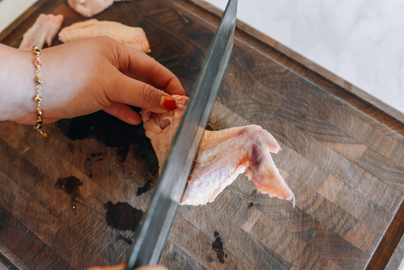 getting ready to slice through chicken wing with knife