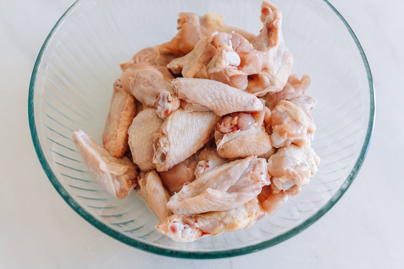 four pounds chicken wings in glass pyrex mixing bowl