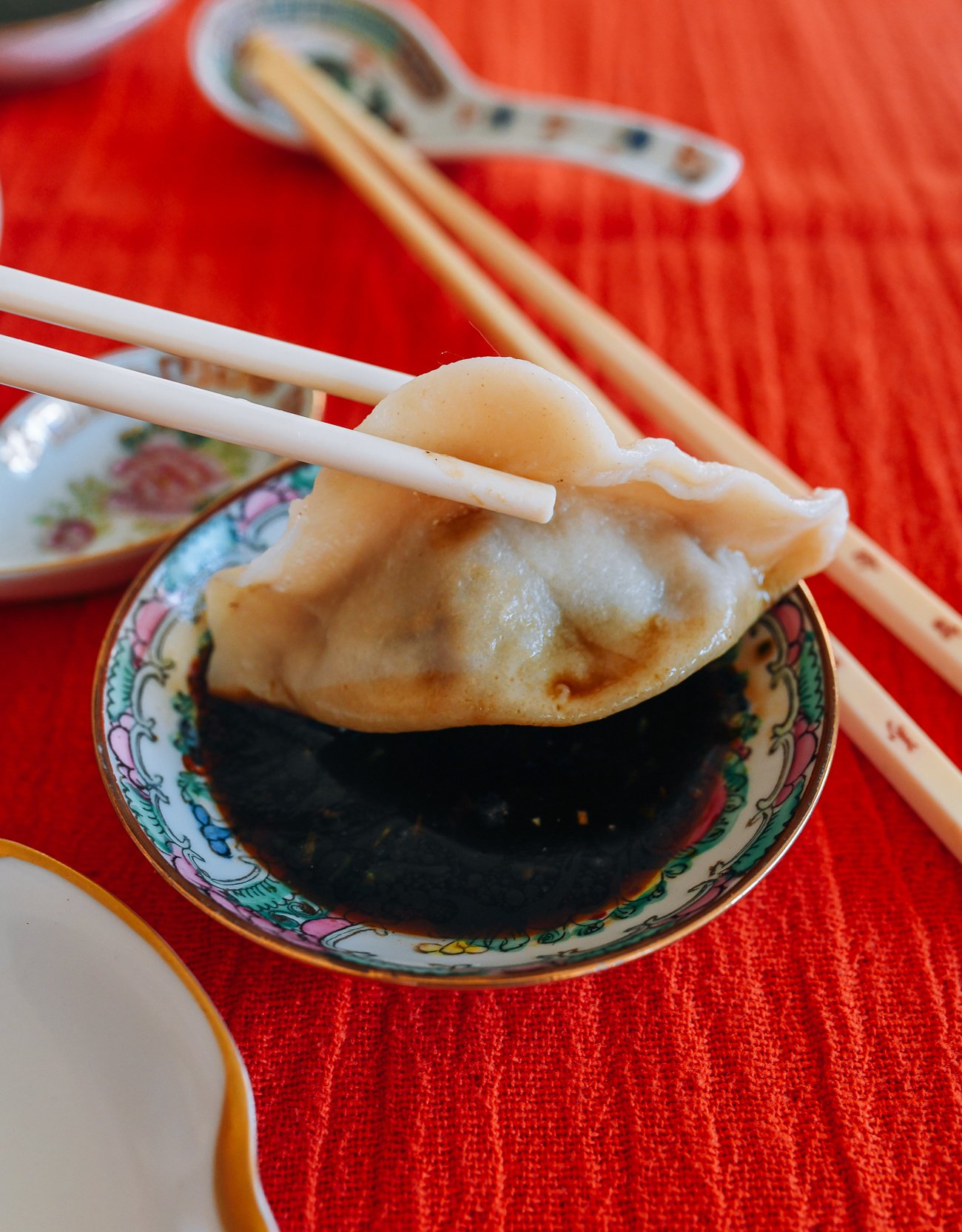 dipping beef dumpling into Chinese black vinegar