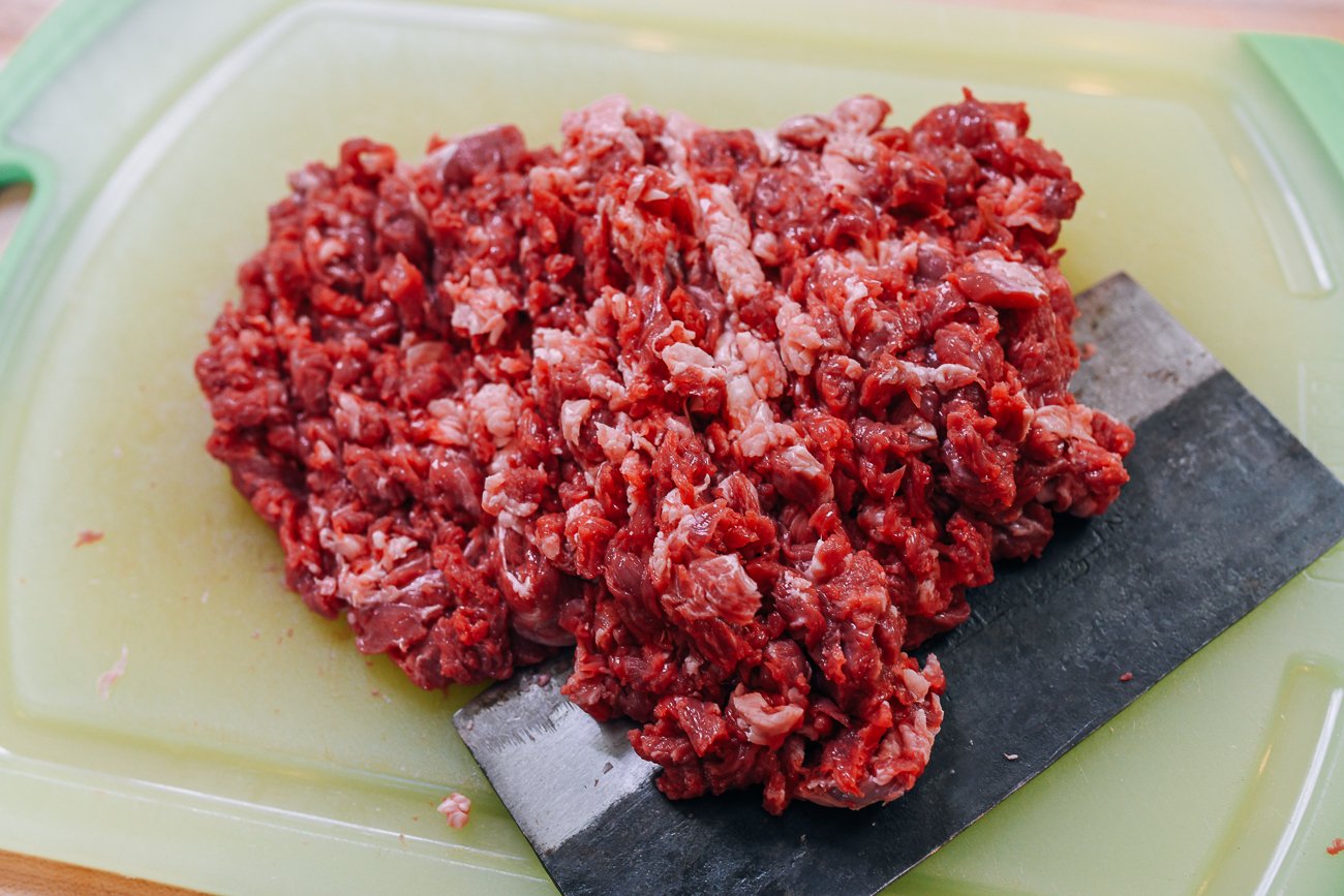 hand-chopped meat on cutting board