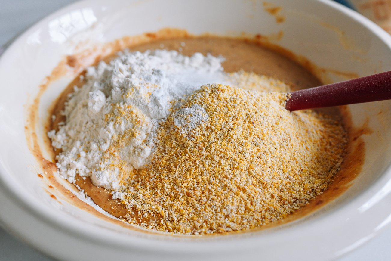 adding dry ingredients to cornbread batter
