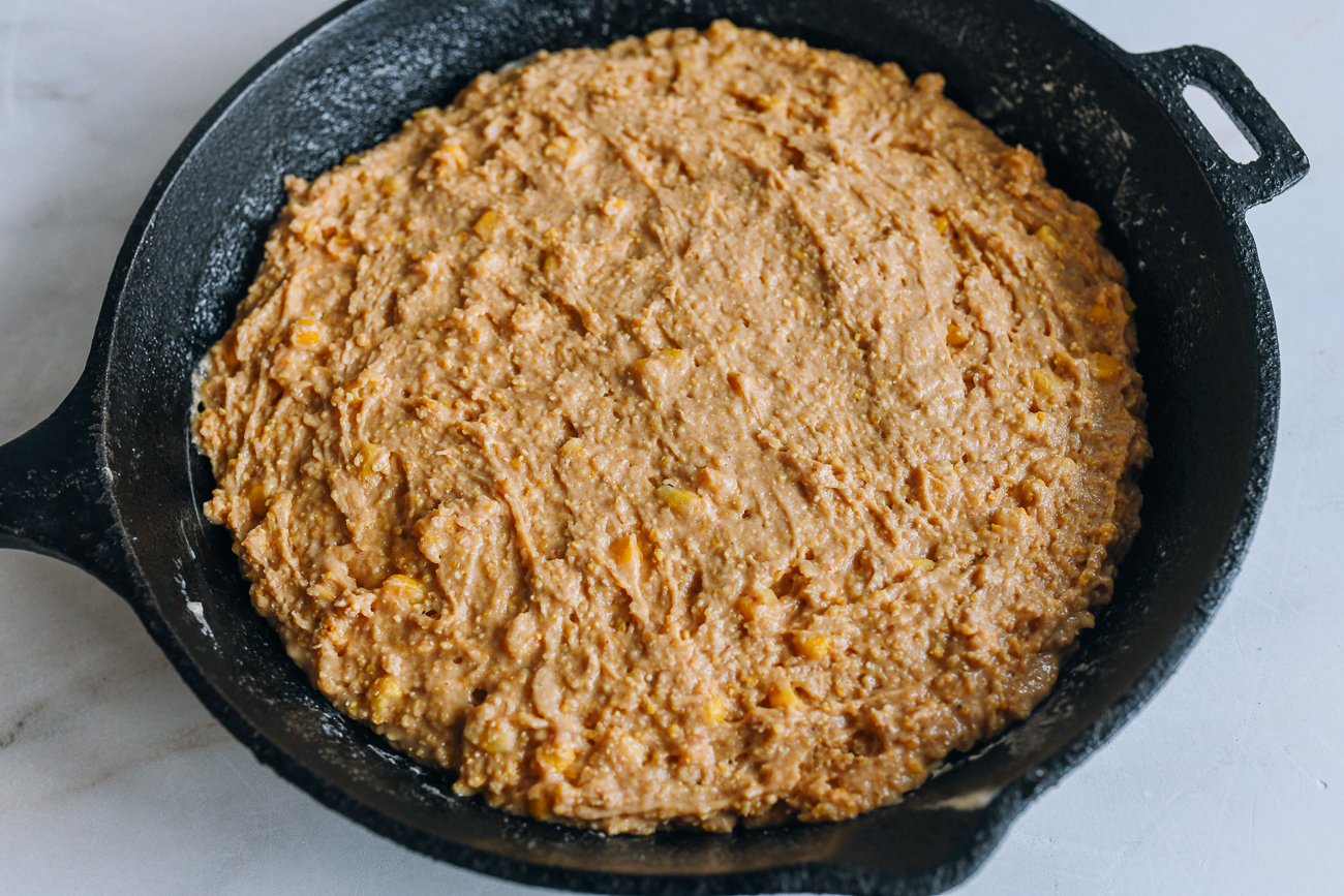 cornbread batter in greased cast iron pan