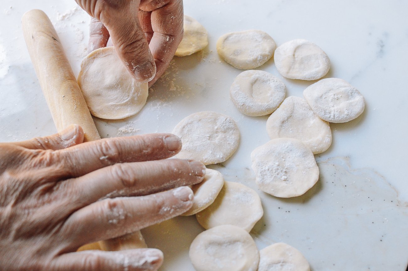rolling dumpling dough into wrappers