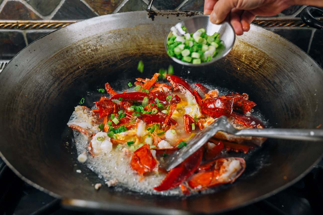adding scallions to lobster in eggs
