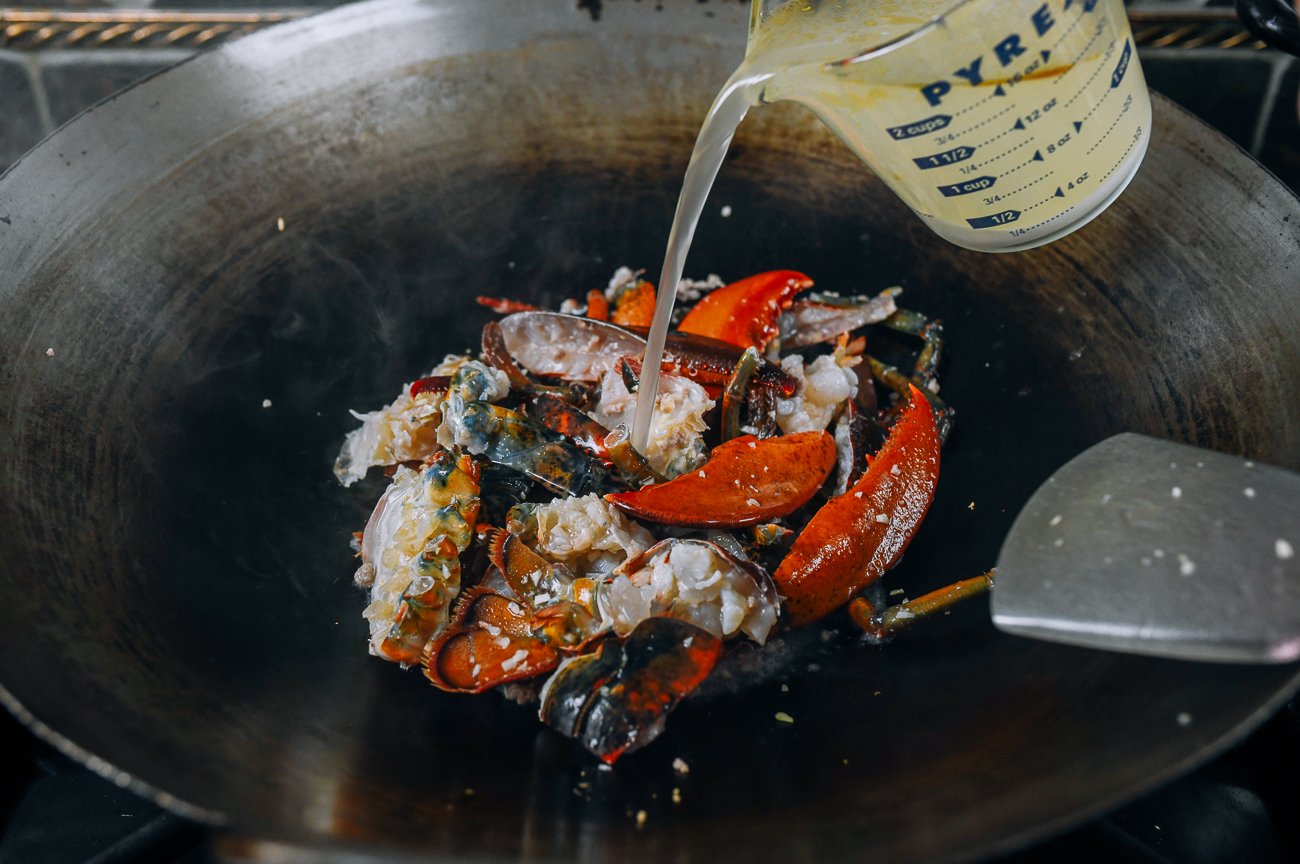 adding stock mixture to lobster