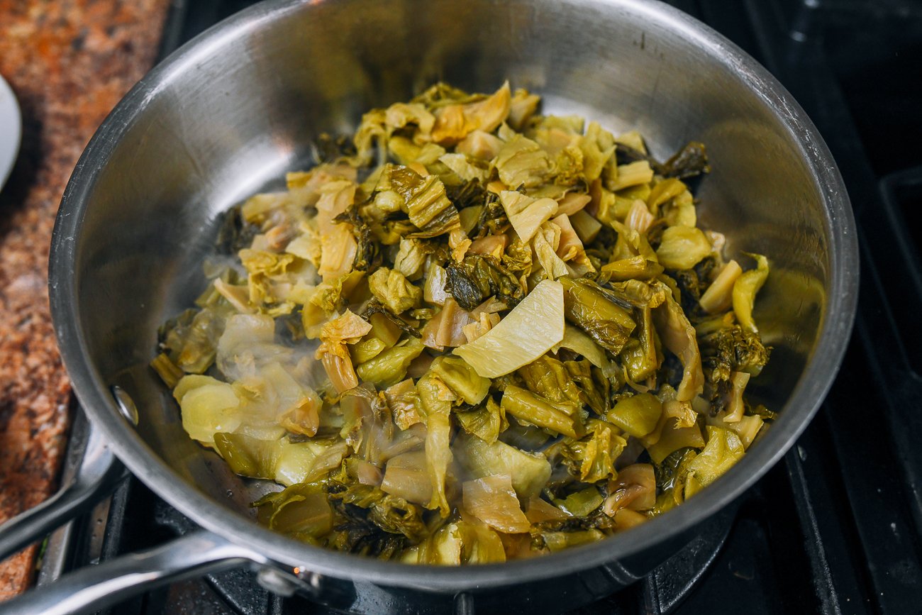 chopped mustard leaves in the pan