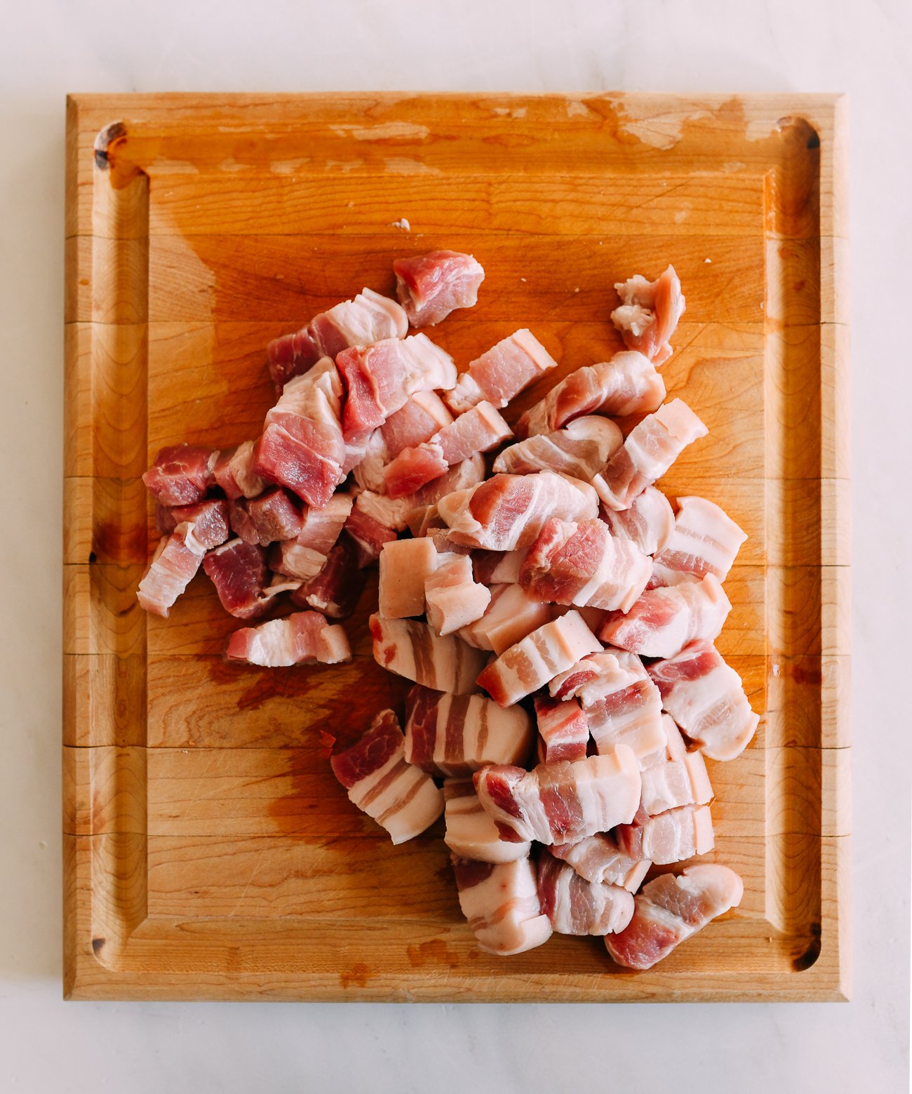pork belly cut into pieces on cutting board