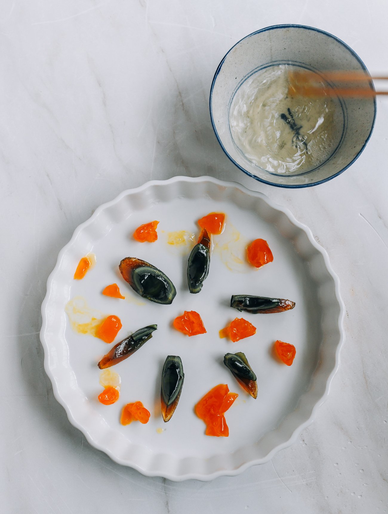 salted duck egg yolks and century eggs in circular dish