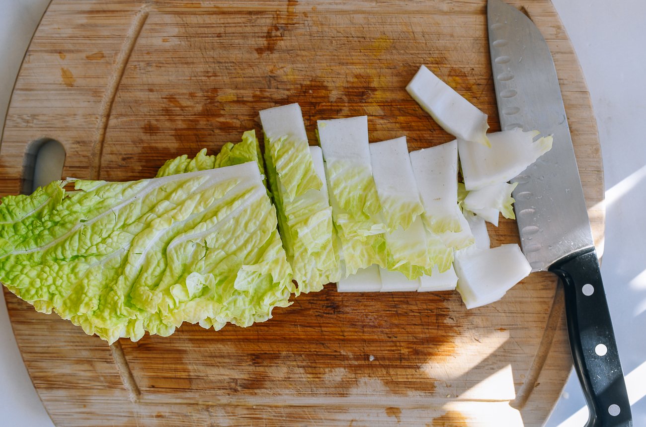 slicing napa cabbage into pieces