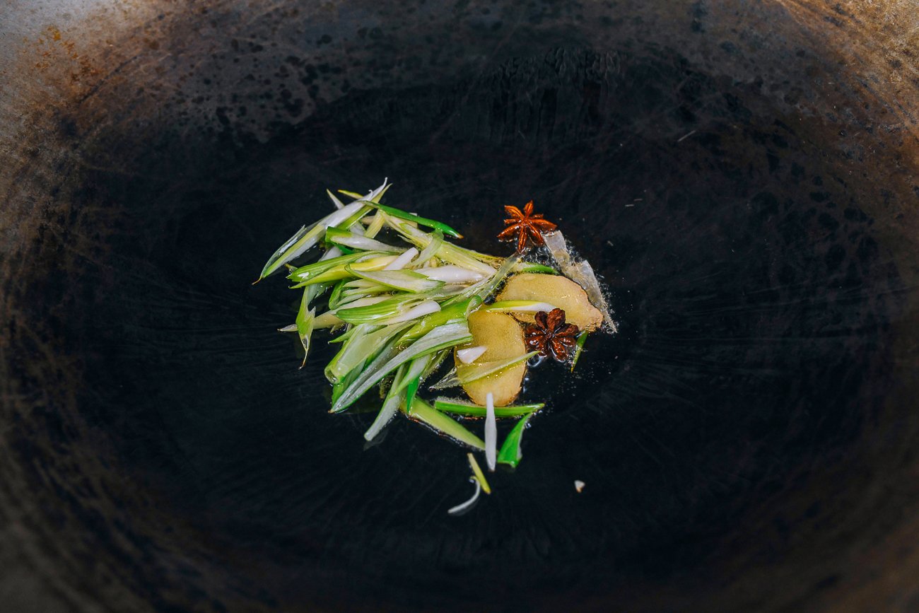 scallion, ginger, and star anise in wok