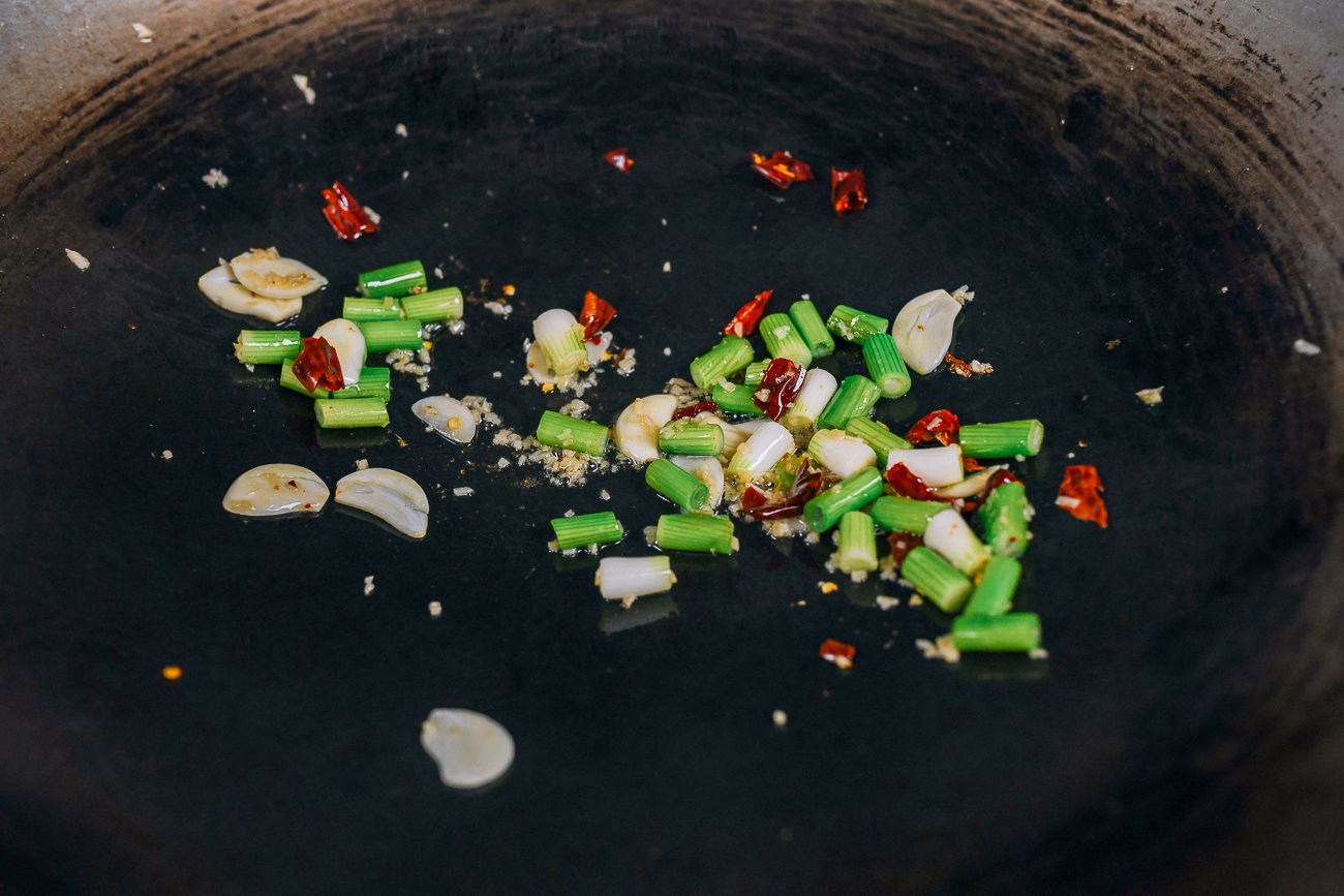 garlic, ginger, chilies, and scallions in wok