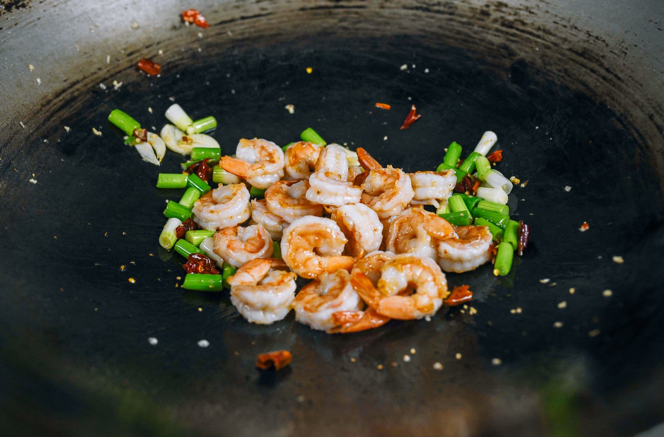 adding shrimp back to wok