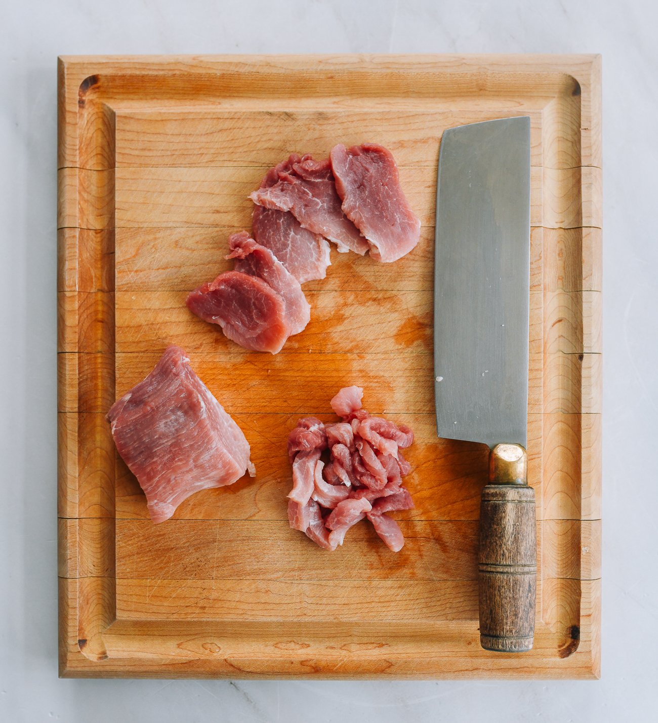 slicing pork into strips