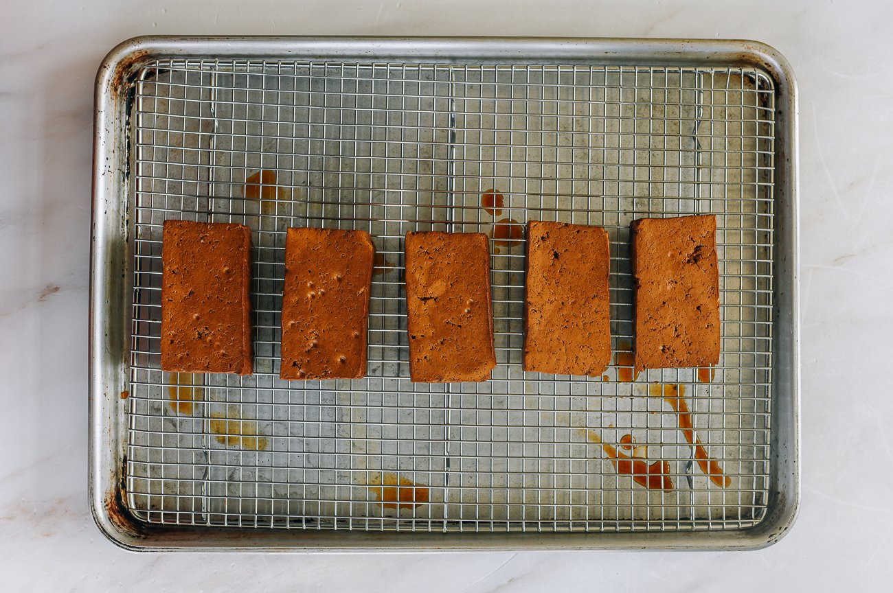 braised tofu pieces on rack on baking sheet