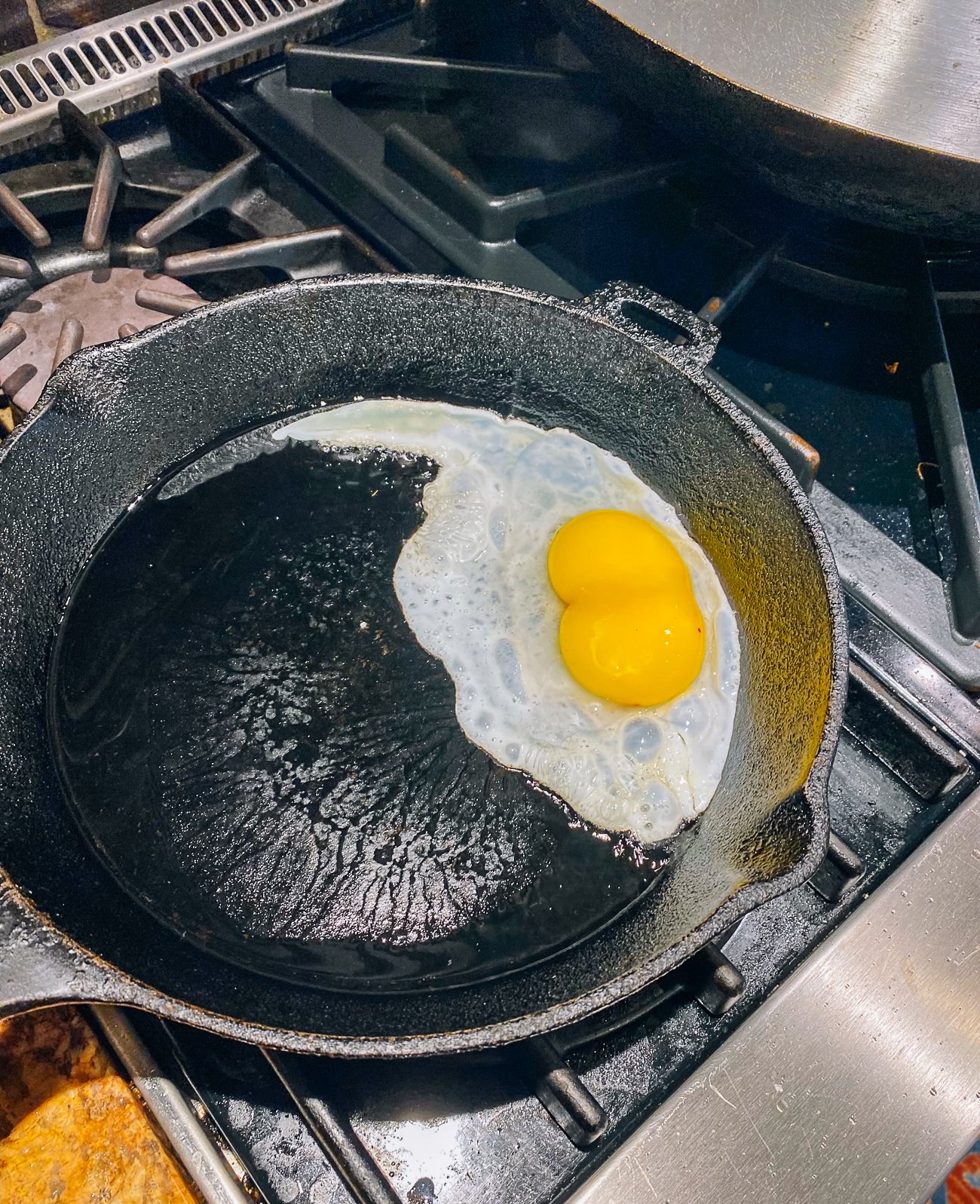 double yolk duck egg in cast iron pan