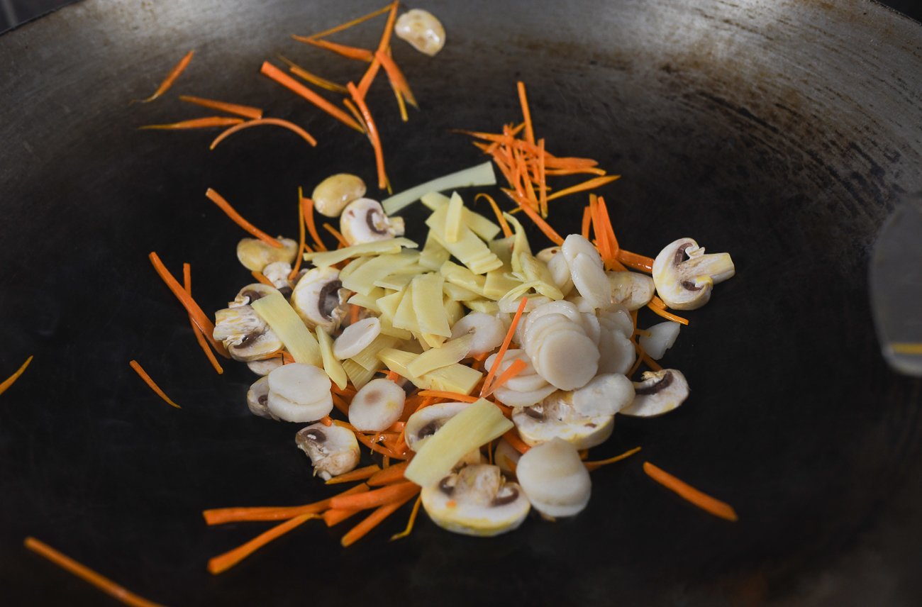 carrot, mushrooms, bamboo shoots, water chestnuts in wok