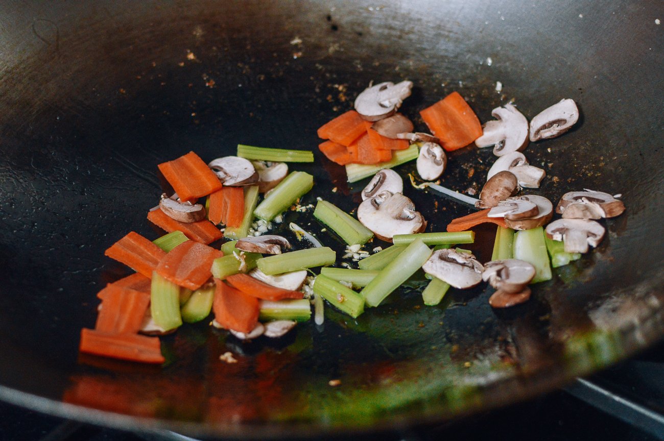stir-frying vegetables to make chop suey