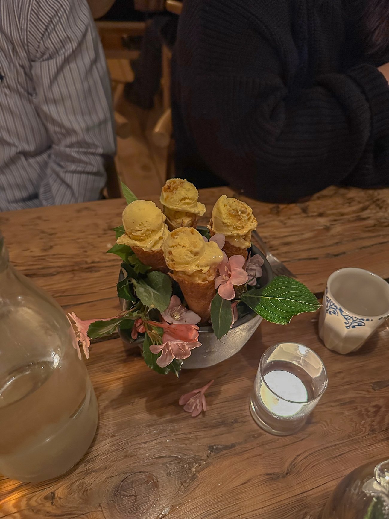 Four mini ice cream cones served in a bed of flowers at The Lost Kitchen
