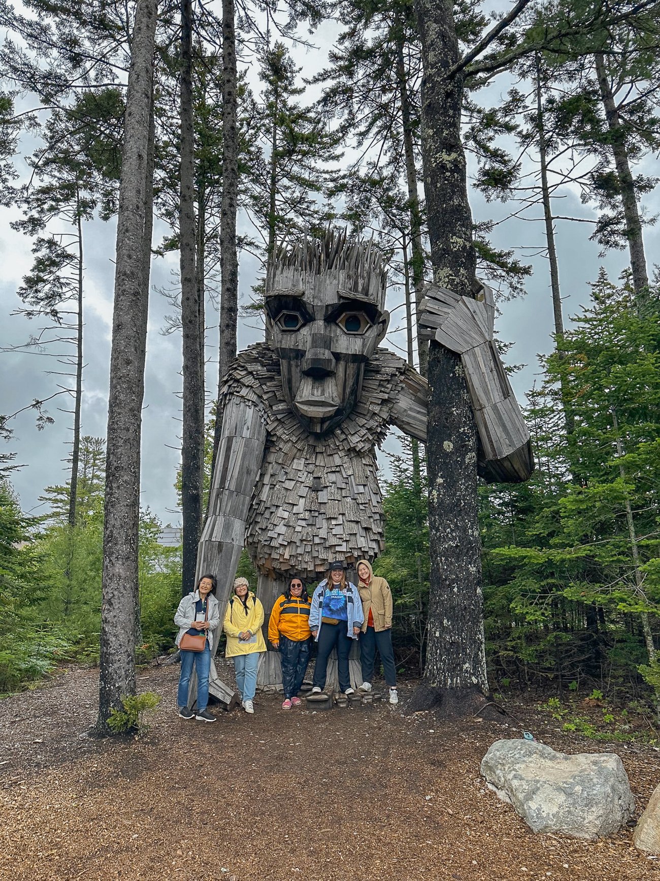 Group photo under a troll made of wood at the Coastal Maine Botanical Garden