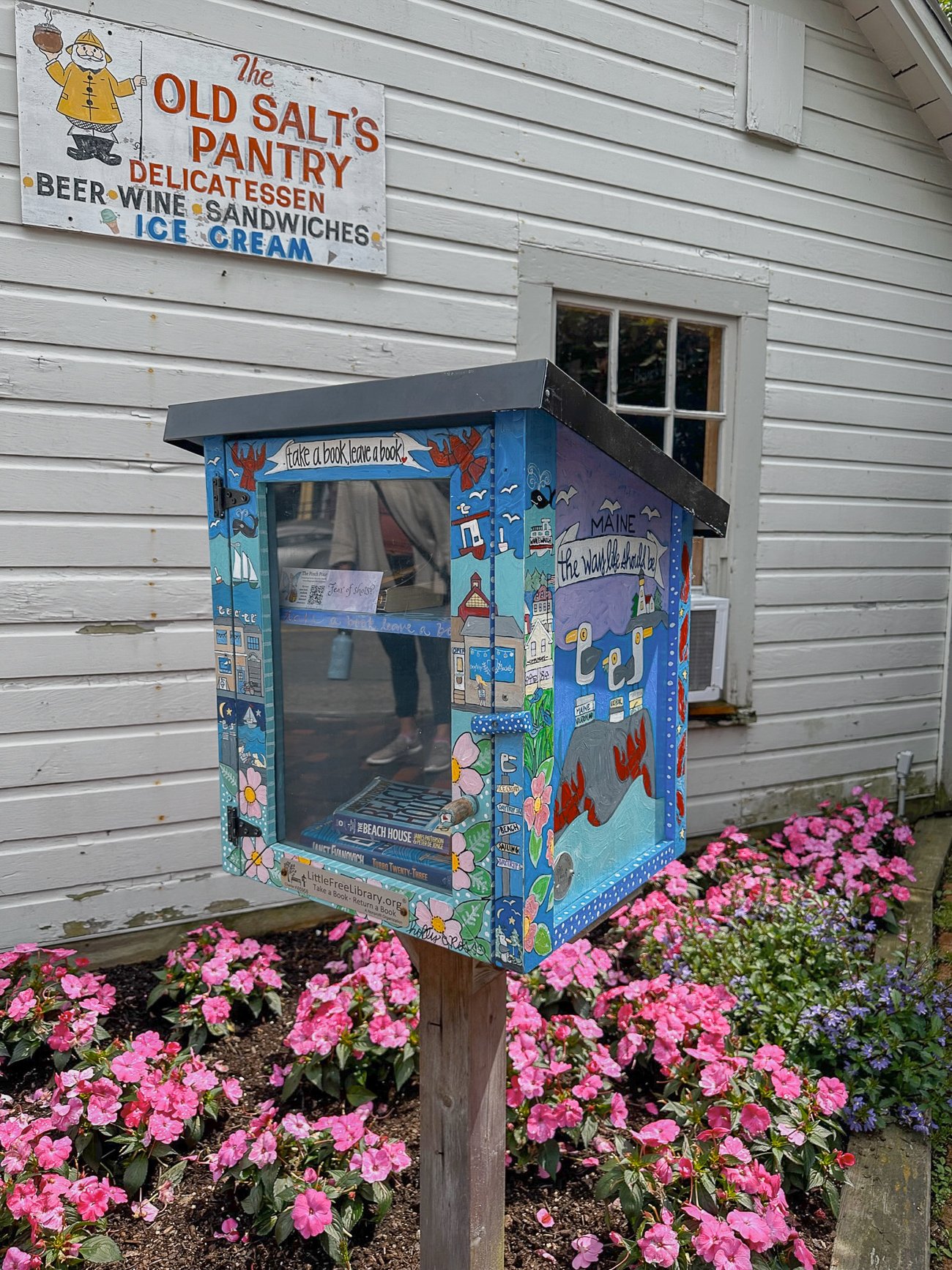 Have a book take a book in Kennebunkport painted with lobsters, seagulls, flowers, and the ocean