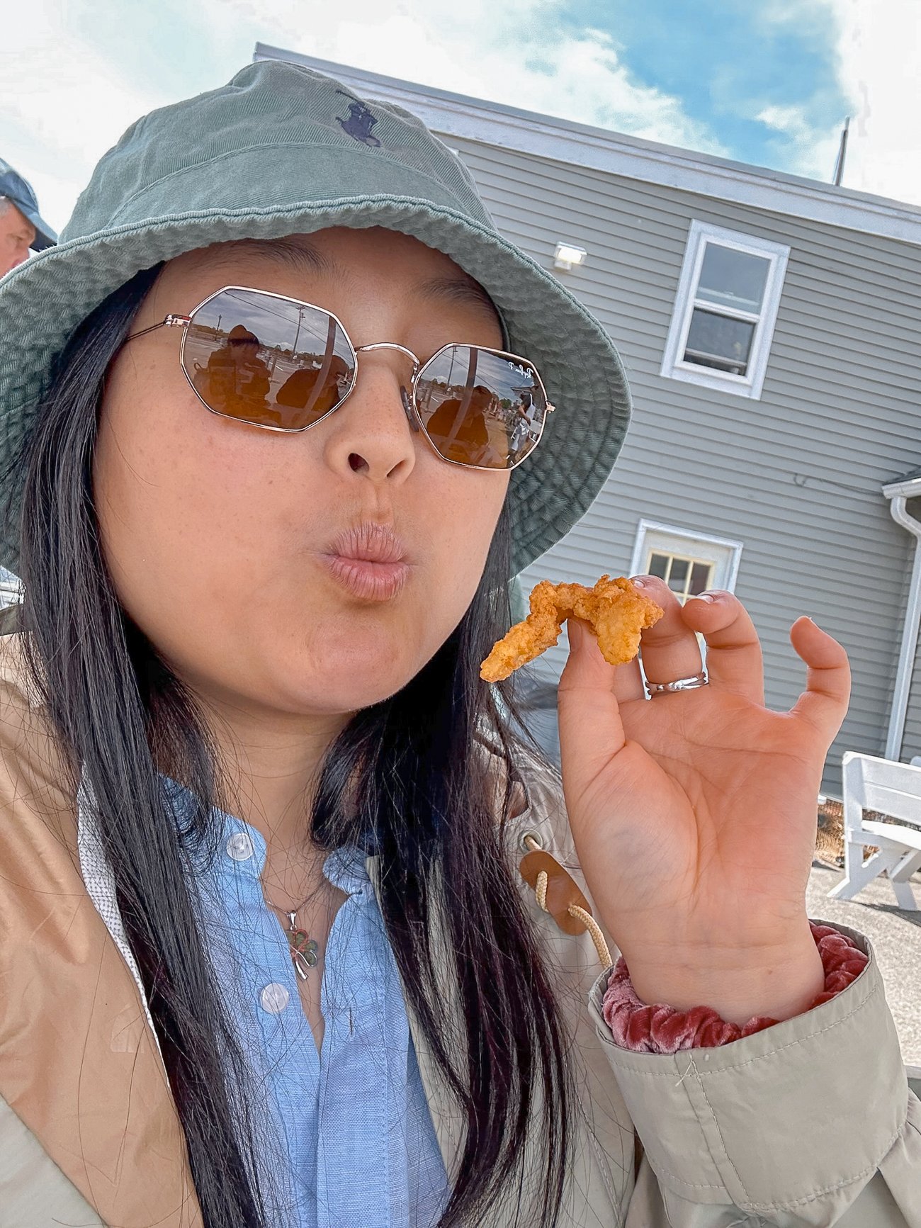 Kaitlin holding a fried clam strip