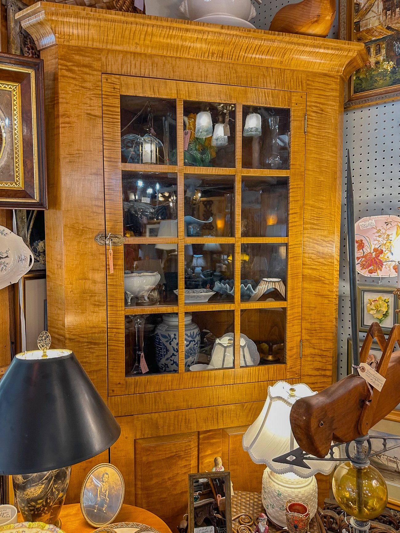 Tiger wood cabinet filled with antiques Wiscasset Antique Mall