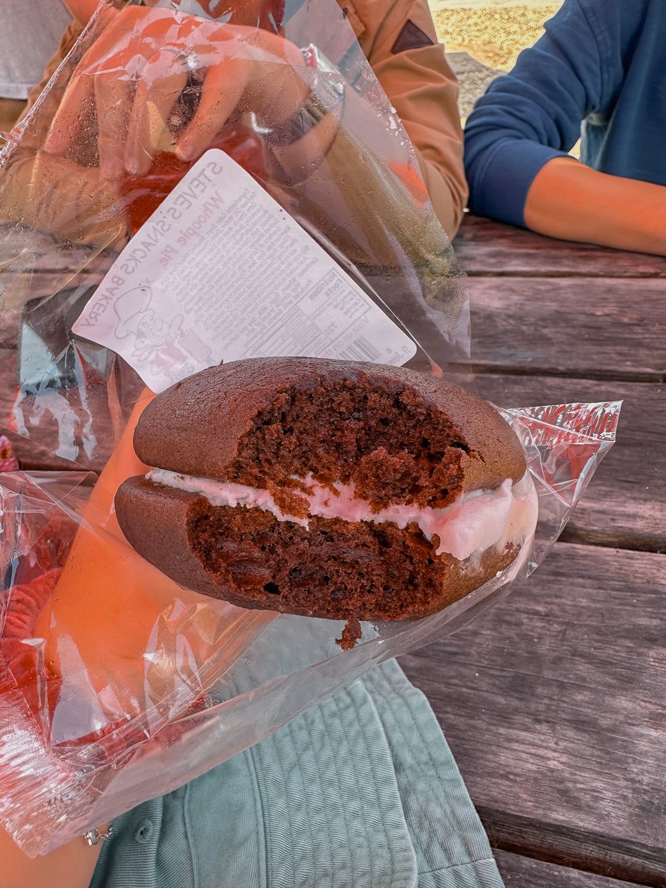 A chocolate whoopie pie with a bite taken out