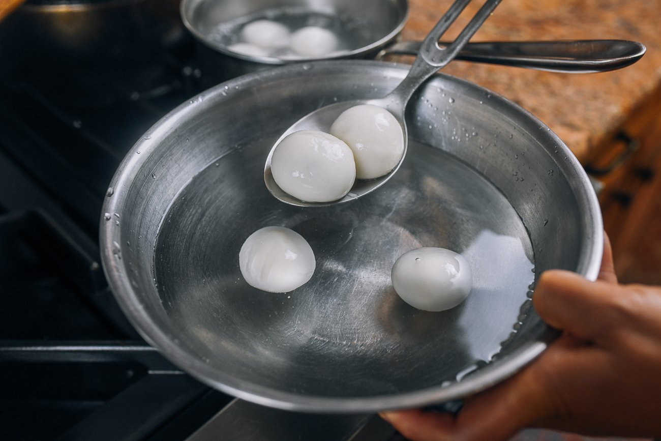 transferring boiling tang yuan to bowl of cold water