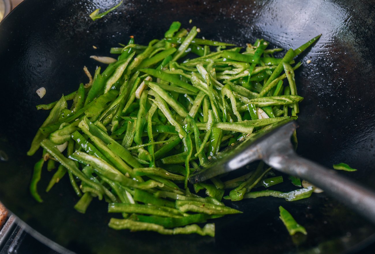 julienned green pepper in wok