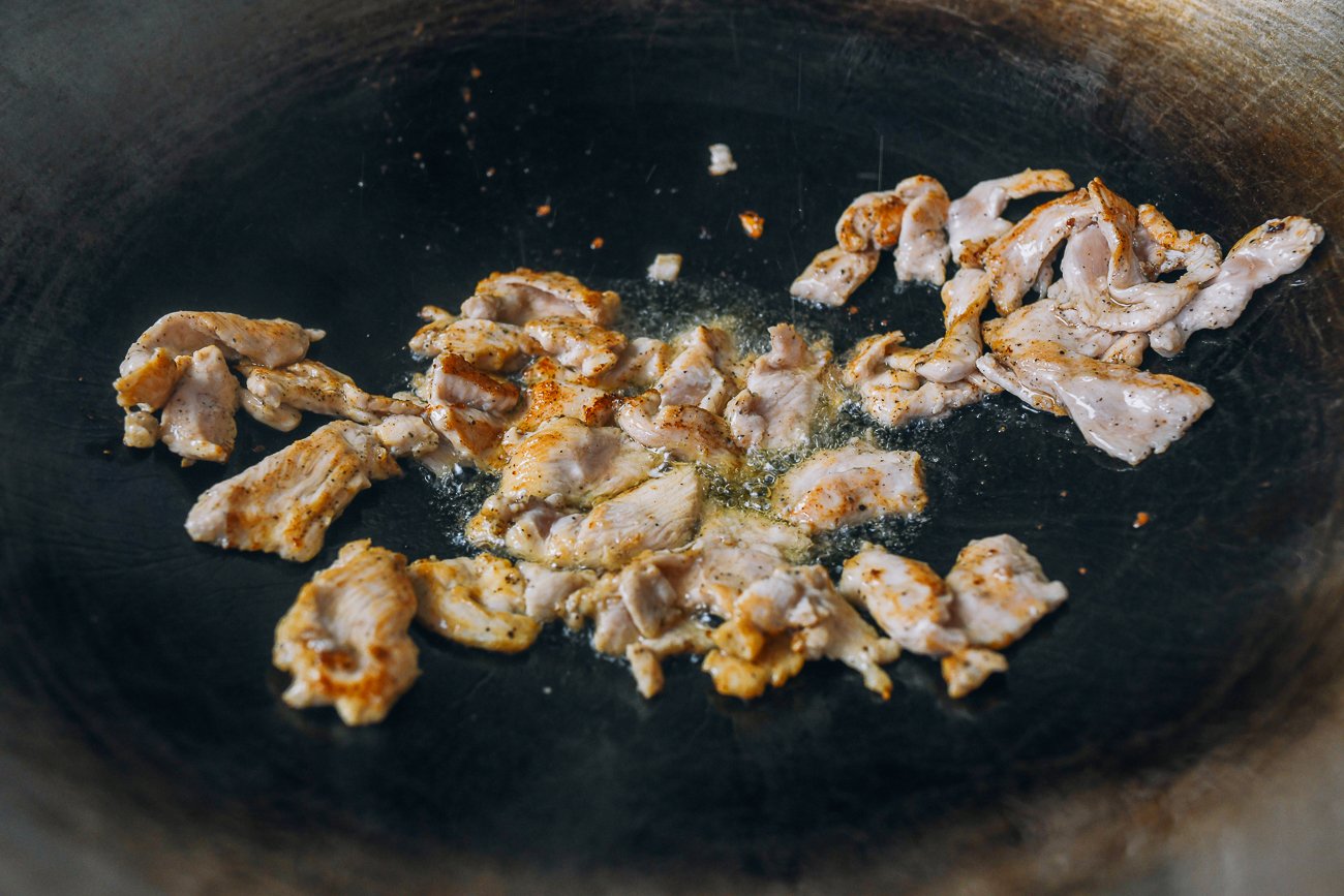searing chicken in wok