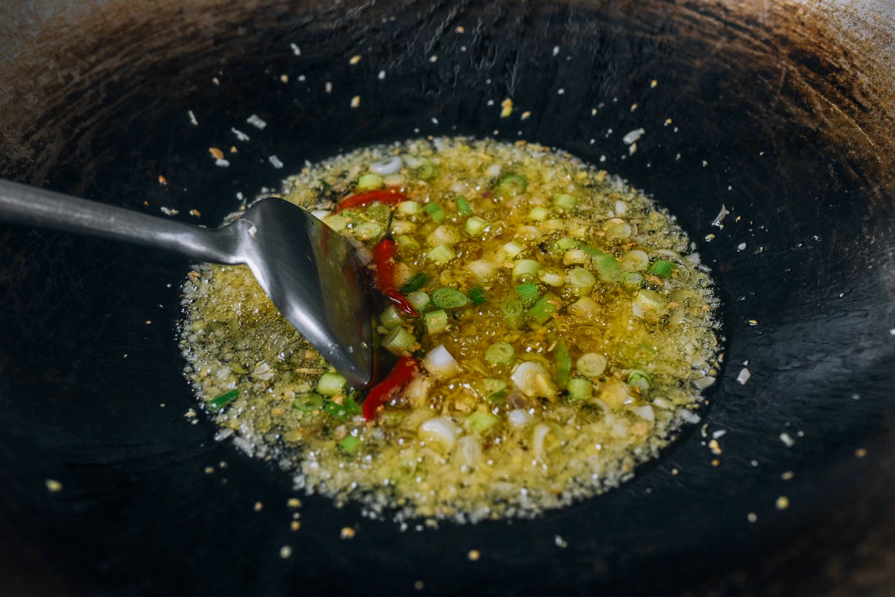 ginger, garlic, scallion, and chili cooking in oil