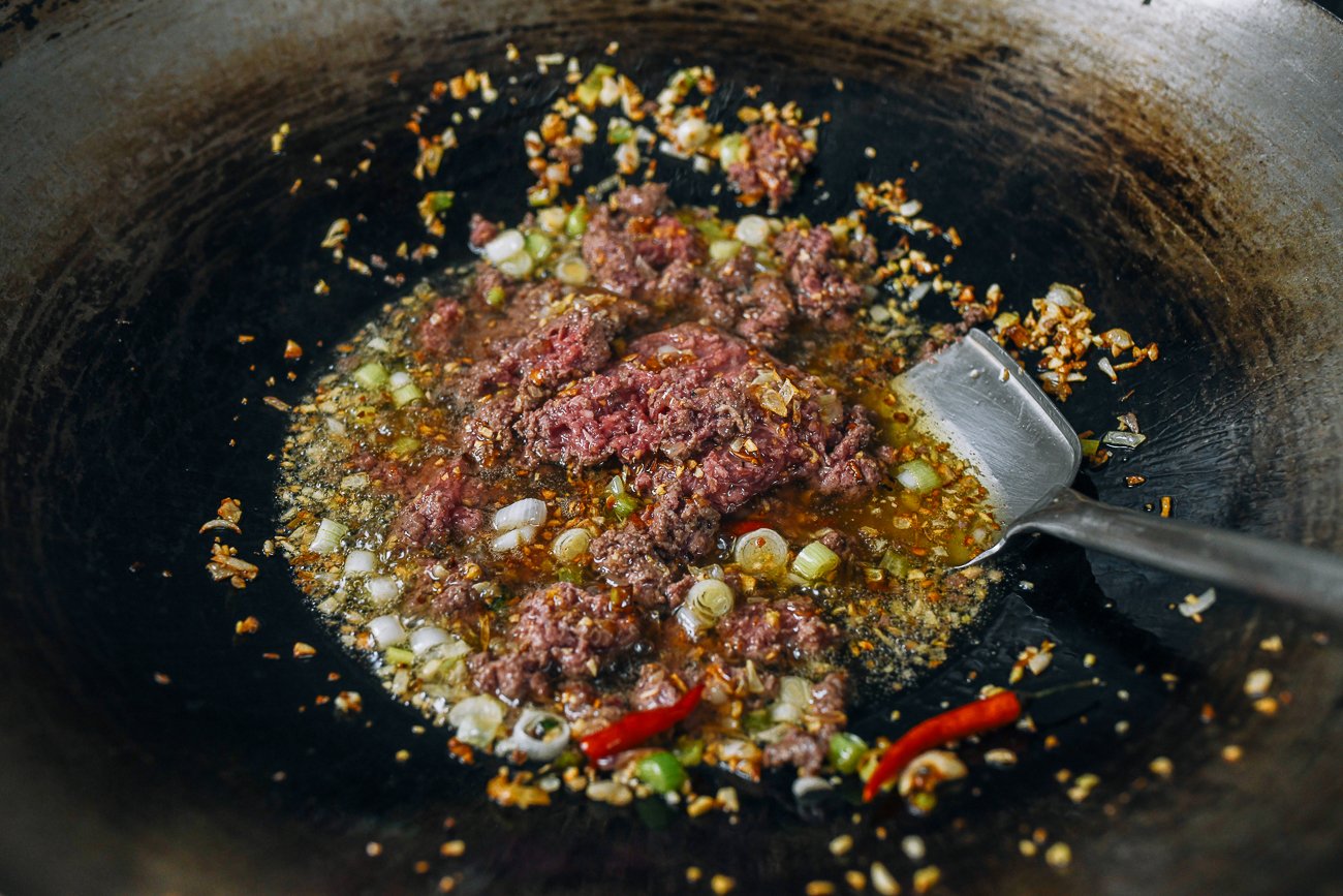 adding ground meat to oil and aromatics