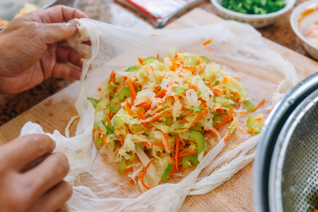 blanched shredded carrots, cabbage, and celery in cheesecloth