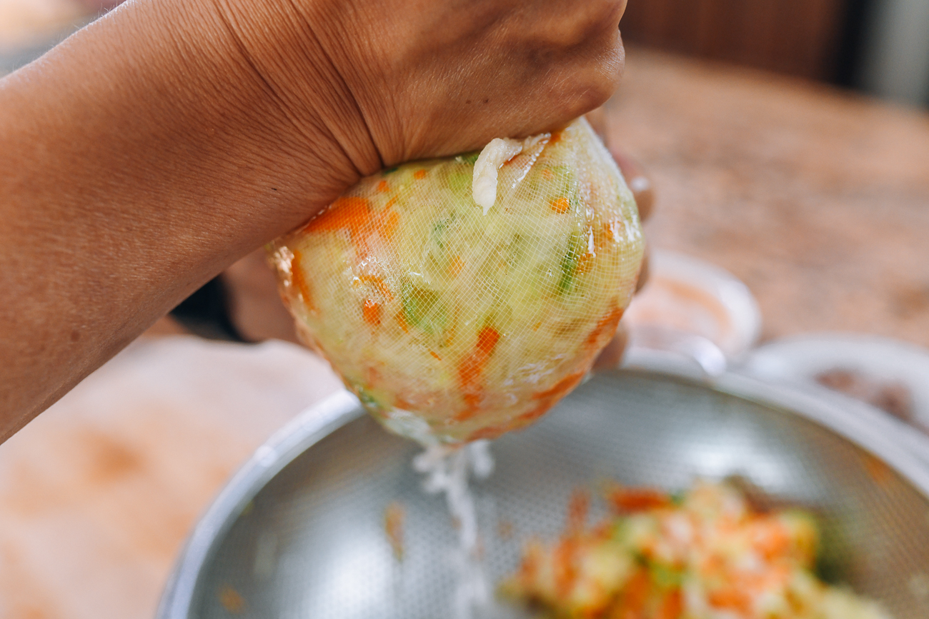 squeezing water out of blanched vegetables using cheesecloth