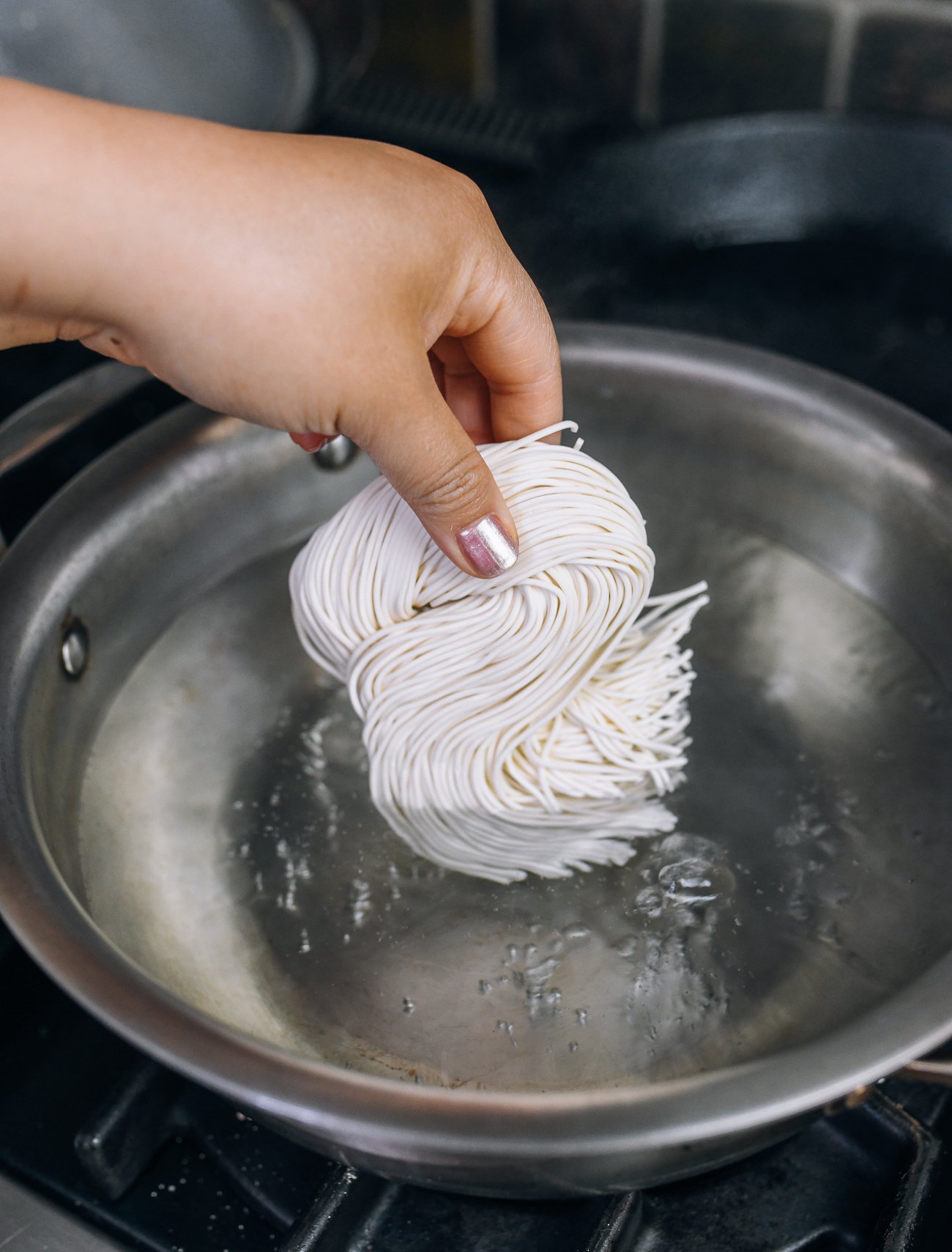 adding fresh noodles to boiling water