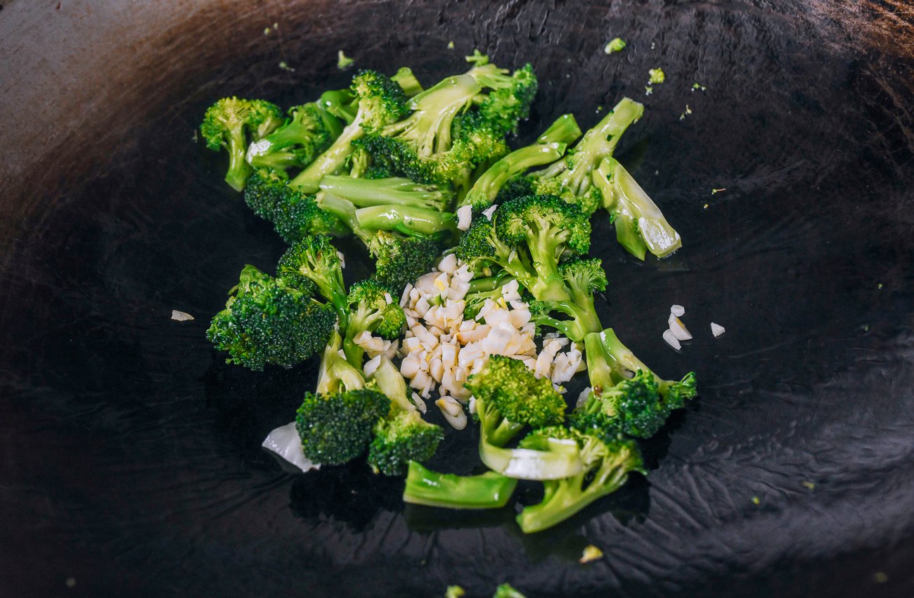 adding garlic to broccoli