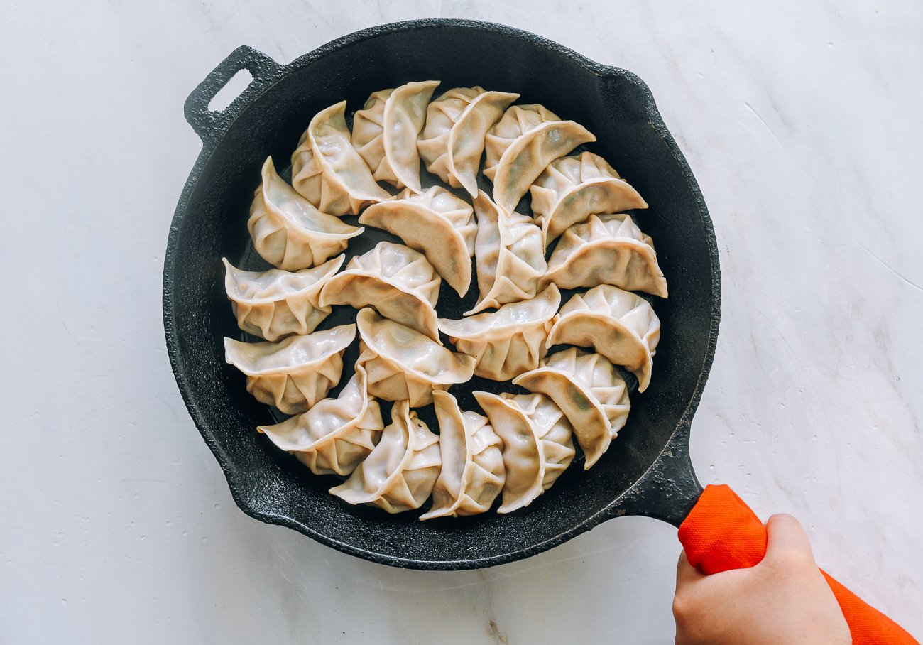 pan-fried dumplings in cast iron skillet