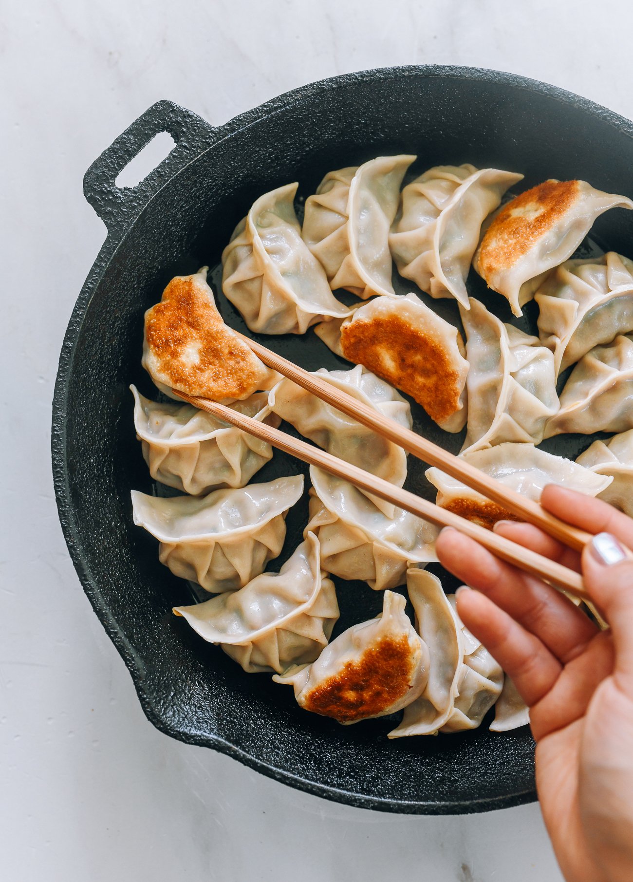 pan-fried dumplings in cast iron pan