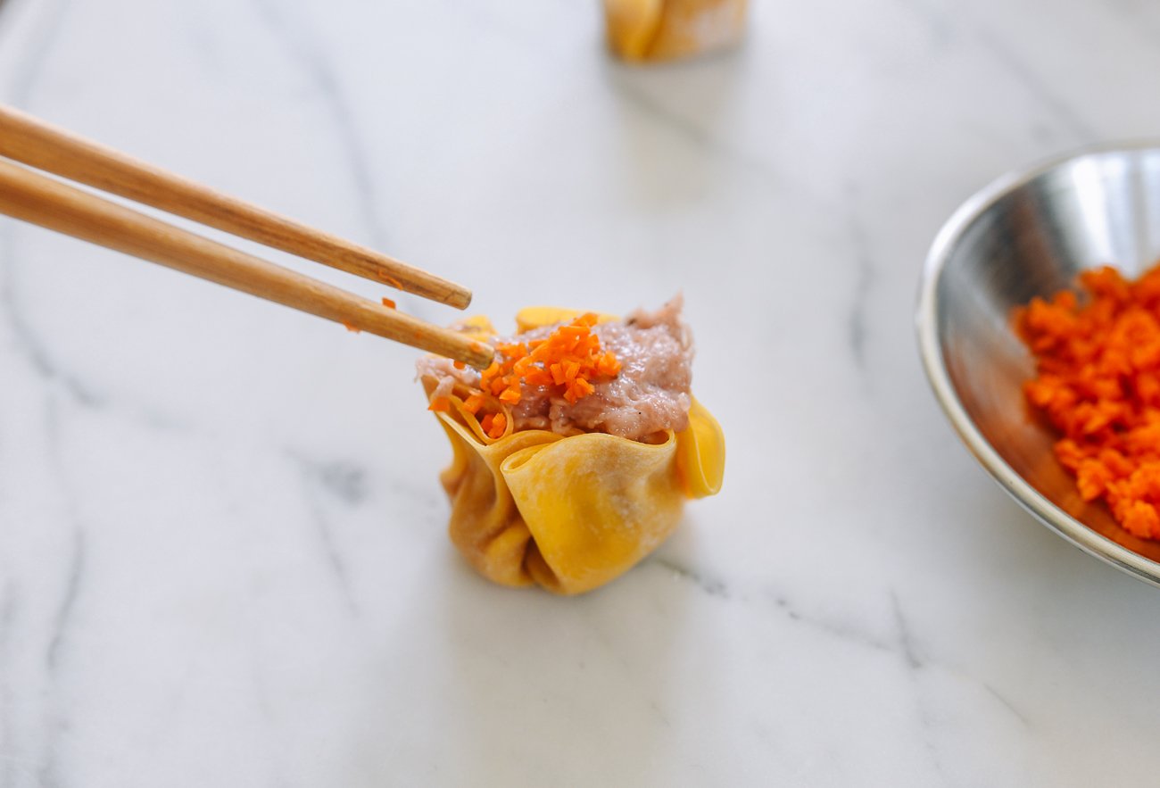 topping siu mai with minced carrot