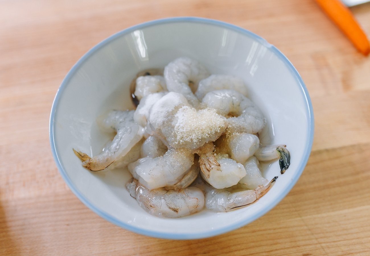 shrimp in bowl with water, sugar, and baking soda