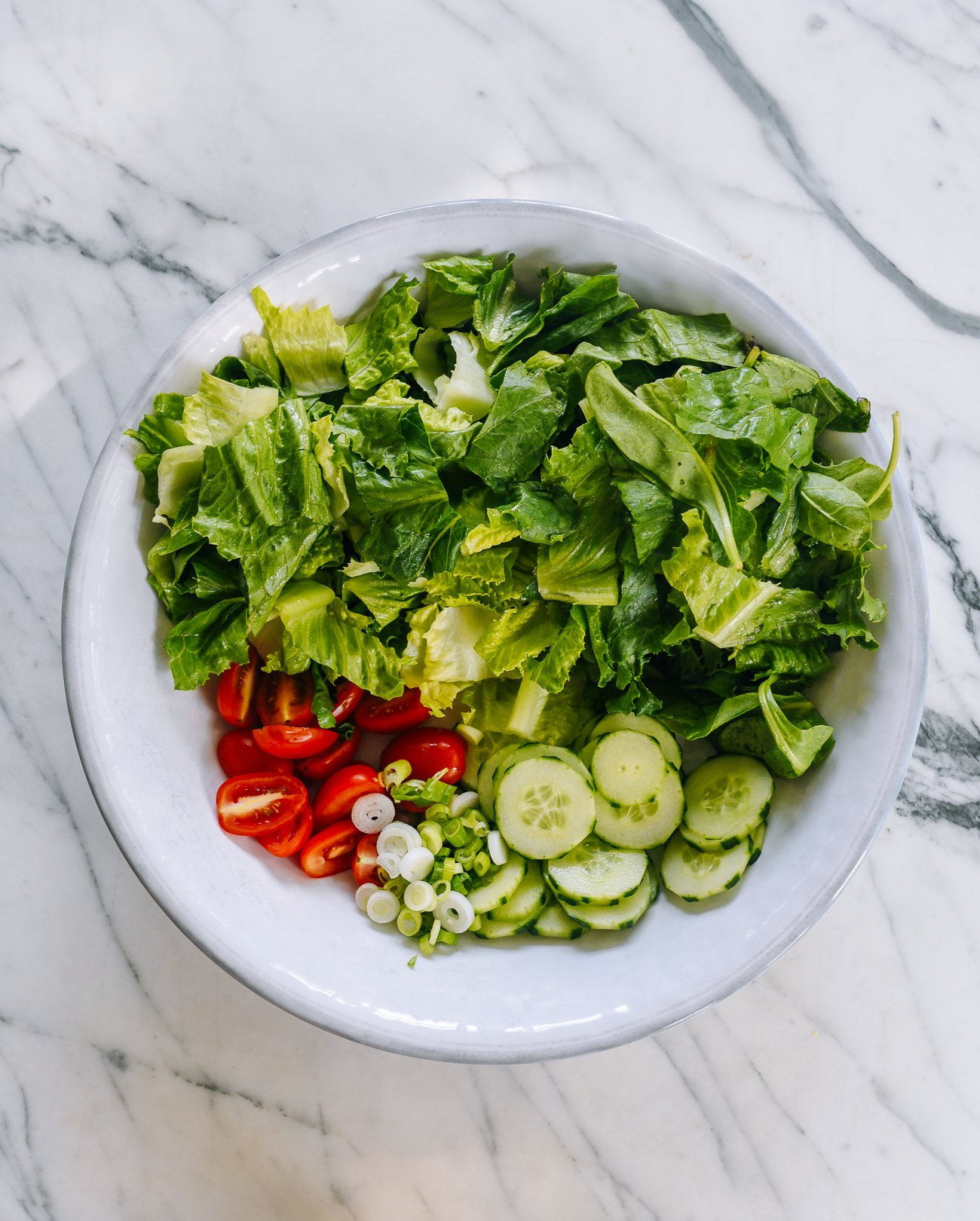 salad ingredients in white bowl