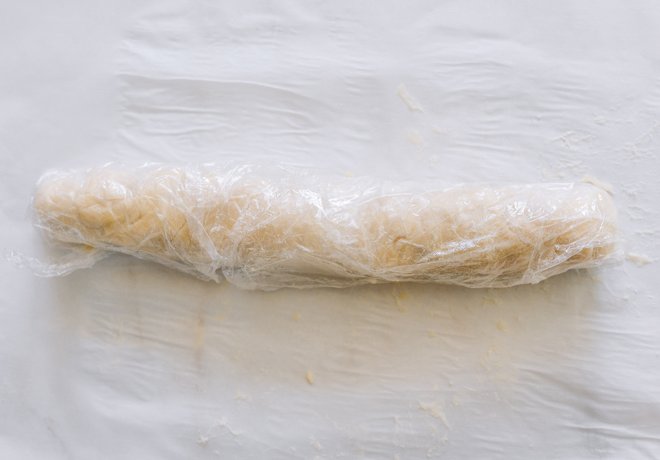 roll of dough covered in plastic wrap