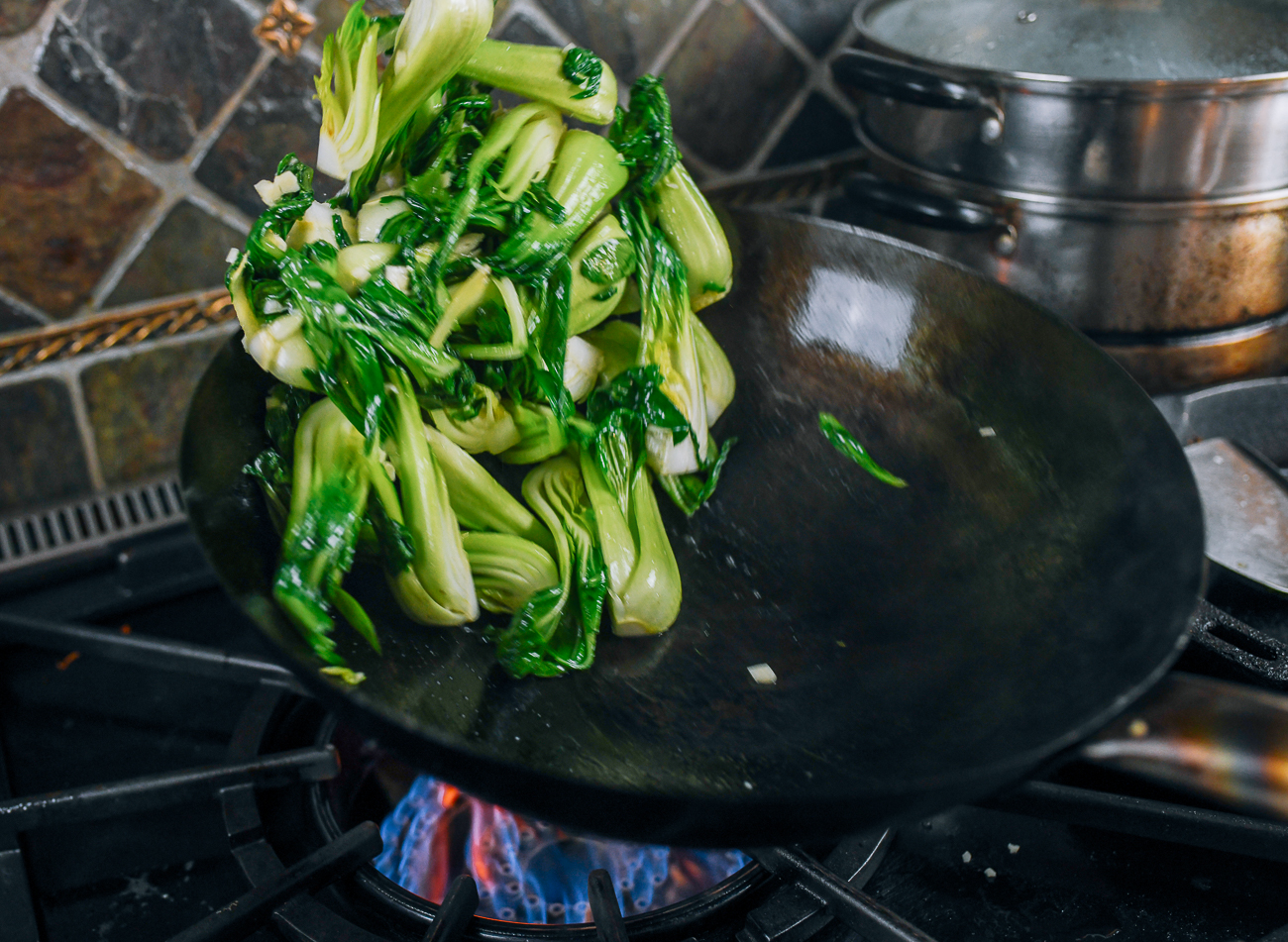 tossing bok choy in wok