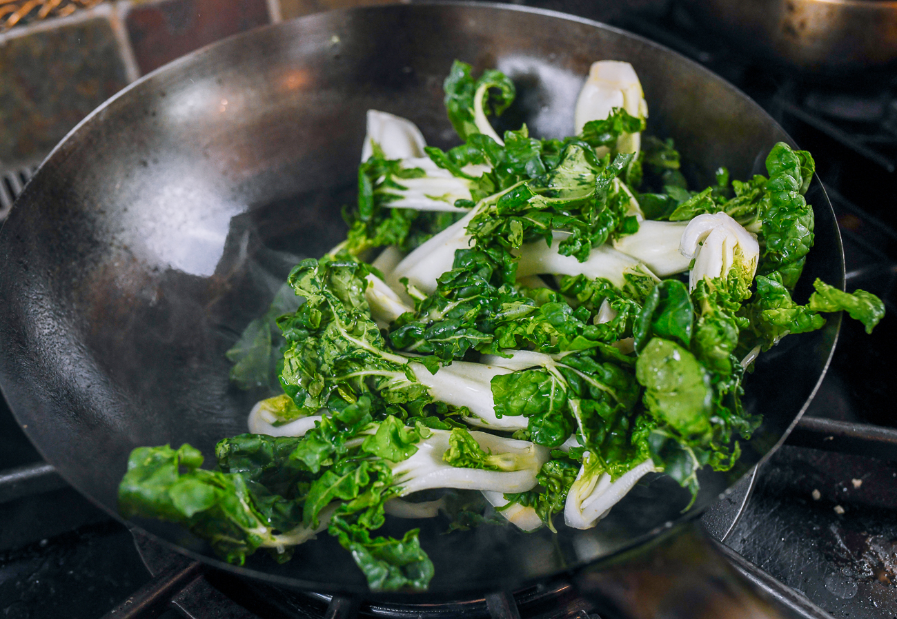 stir-frying dwarf bok choy in wok
