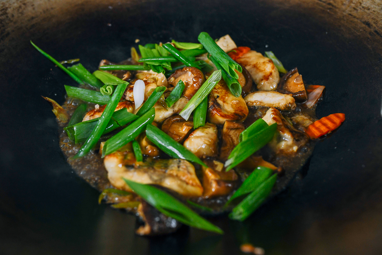 scallion greens added to fish in wok