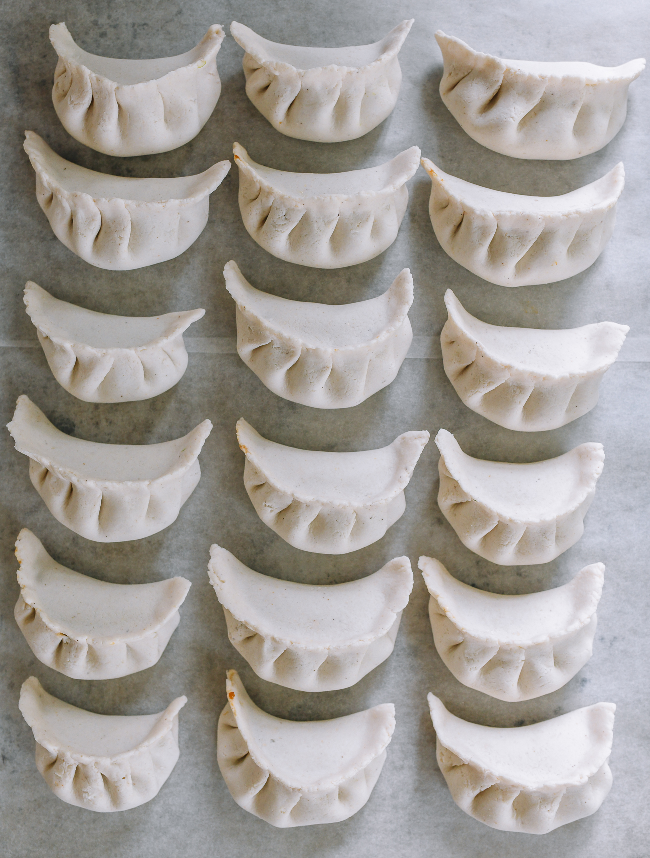 assembled gluten-free dumplings on parchment paper lined tray